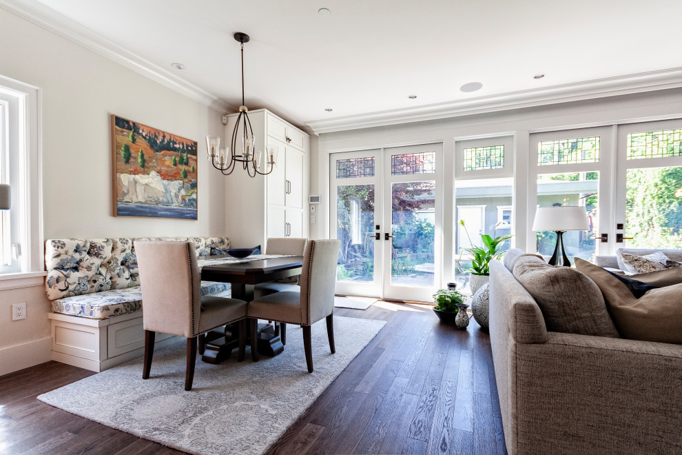 This is an example of a small traditional open plan games room in Vancouver with white walls, dark hardwood flooring, a standard fireplace, a tiled fireplace surround and brown floors.