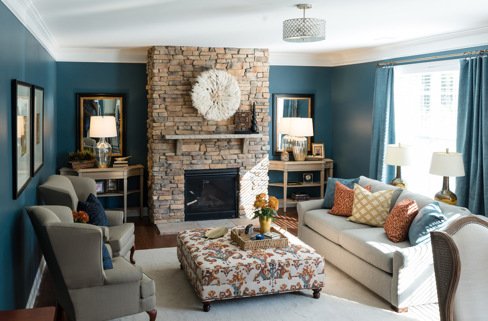 Inspiration for a mid-sized transitional open concept medium tone wood floor and brown floor family room remodel in Charlotte with blue walls, a standard fireplace, a stone fireplace and no tv