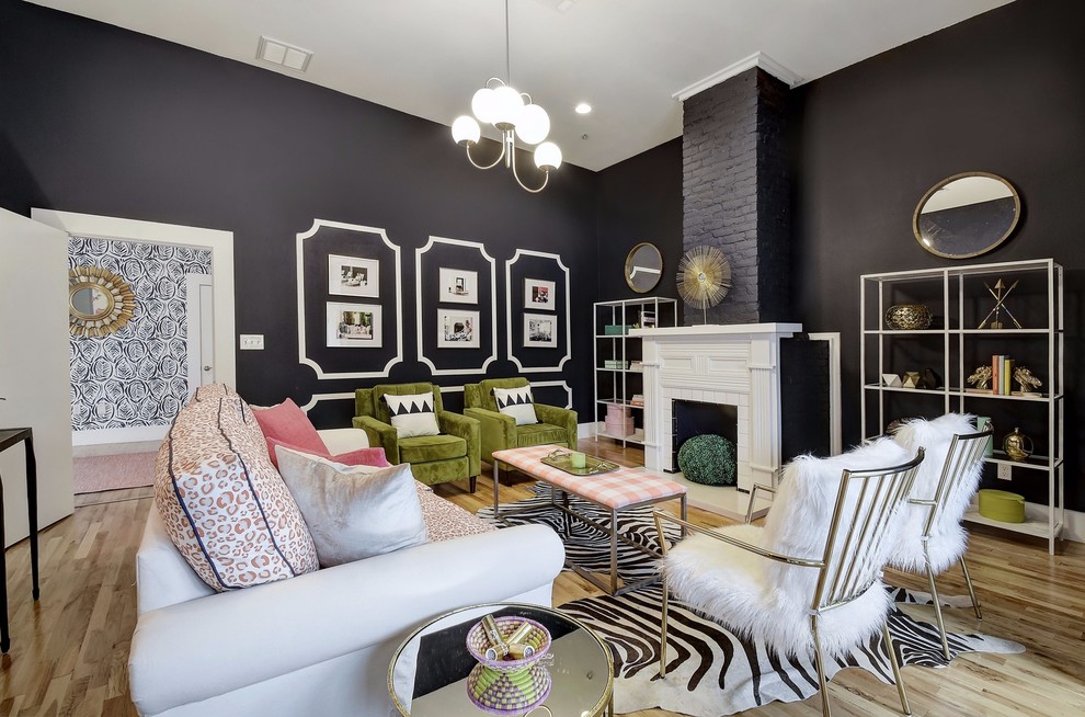 Inspiration for an eclectic enclosed light wood floor and beige floor family room remodel in Austin with black walls, a standard fireplace and a tile fireplace