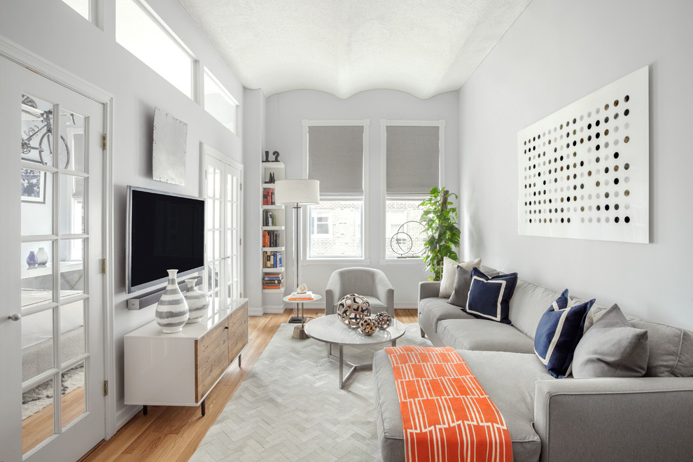 Design ideas for a nautical enclosed games room in New York with grey walls, medium hardwood flooring, a reading nook, no fireplace and a wall mounted tv.