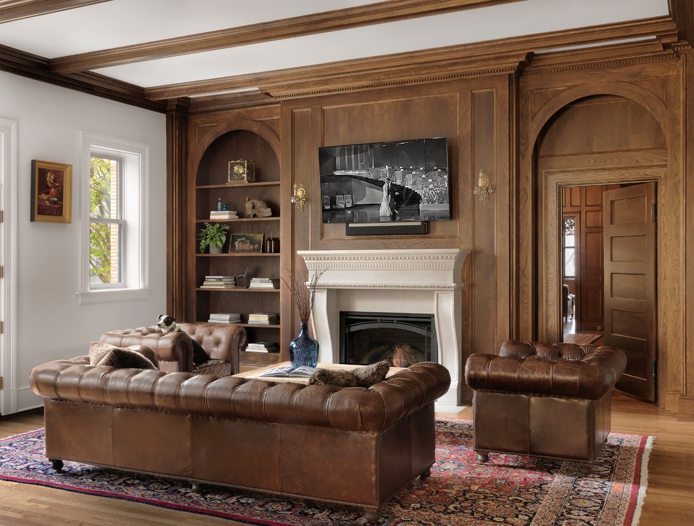 Photo of a traditional games room in St Louis with white walls, medium hardwood flooring, a standard fireplace, a wall mounted tv, brown floors and a feature wall.