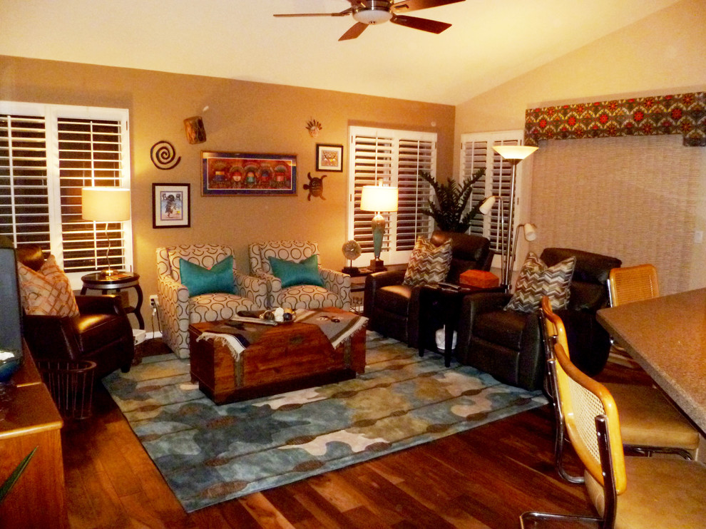 Mid-sized eclectic open concept medium tone wood floor family room photo in Phoenix with beige walls and a tv stand