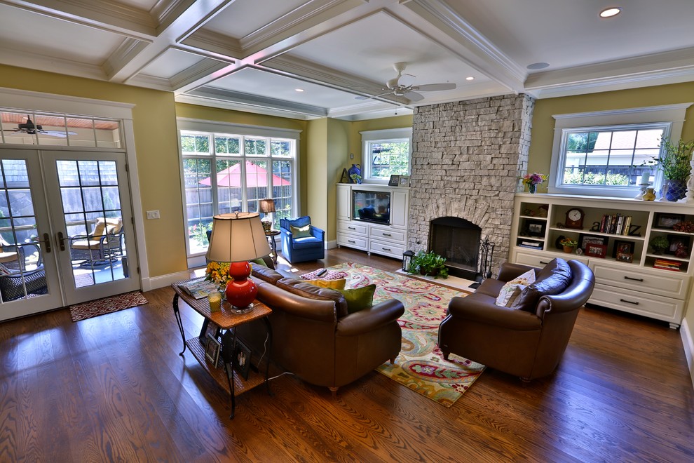 Photo of a medium sized traditional open plan games room in Chicago with yellow walls, dark hardwood flooring, a standard fireplace, a stone fireplace surround and a built-in media unit.