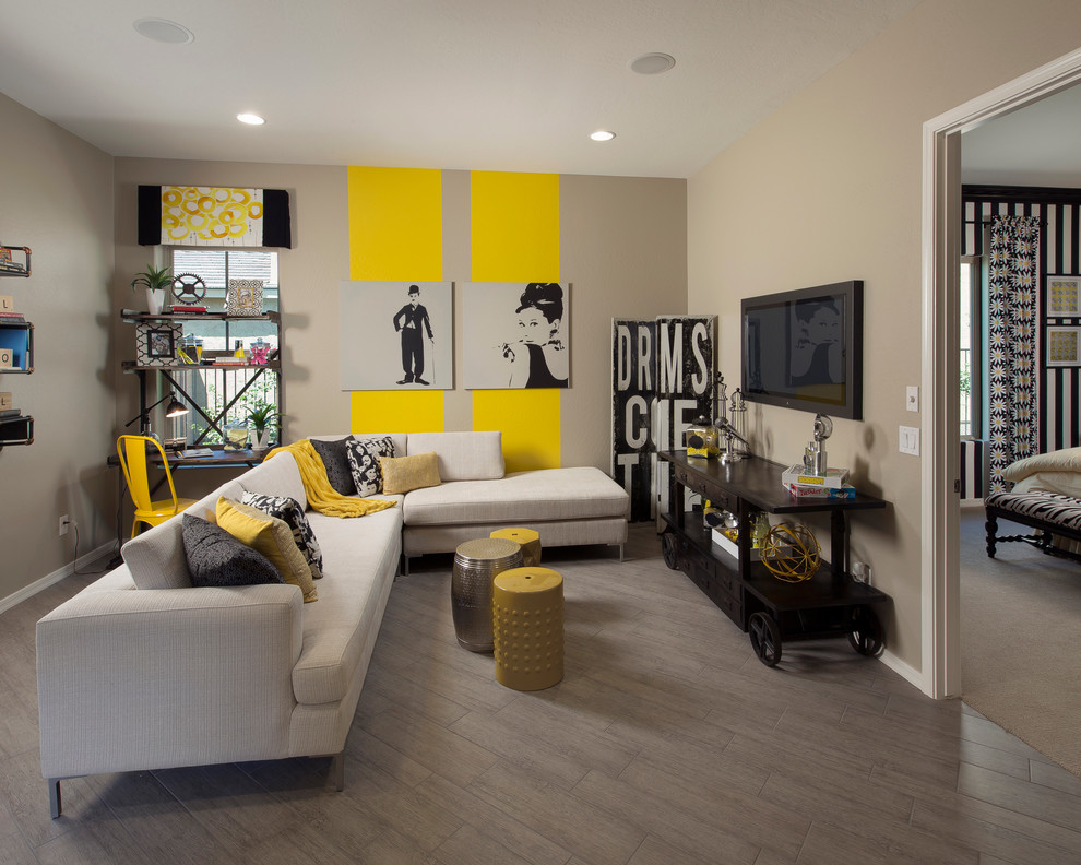 Inspiration for a contemporary family room remodel in Phoenix with yellow walls, no fireplace and a wall-mounted tv
