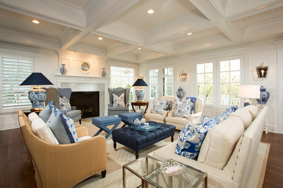 Inspiration for a large coastal open concept medium tone wood floor family room remodel in DC Metro with a standard fireplace, a wood fireplace surround and a wall-mounted tv