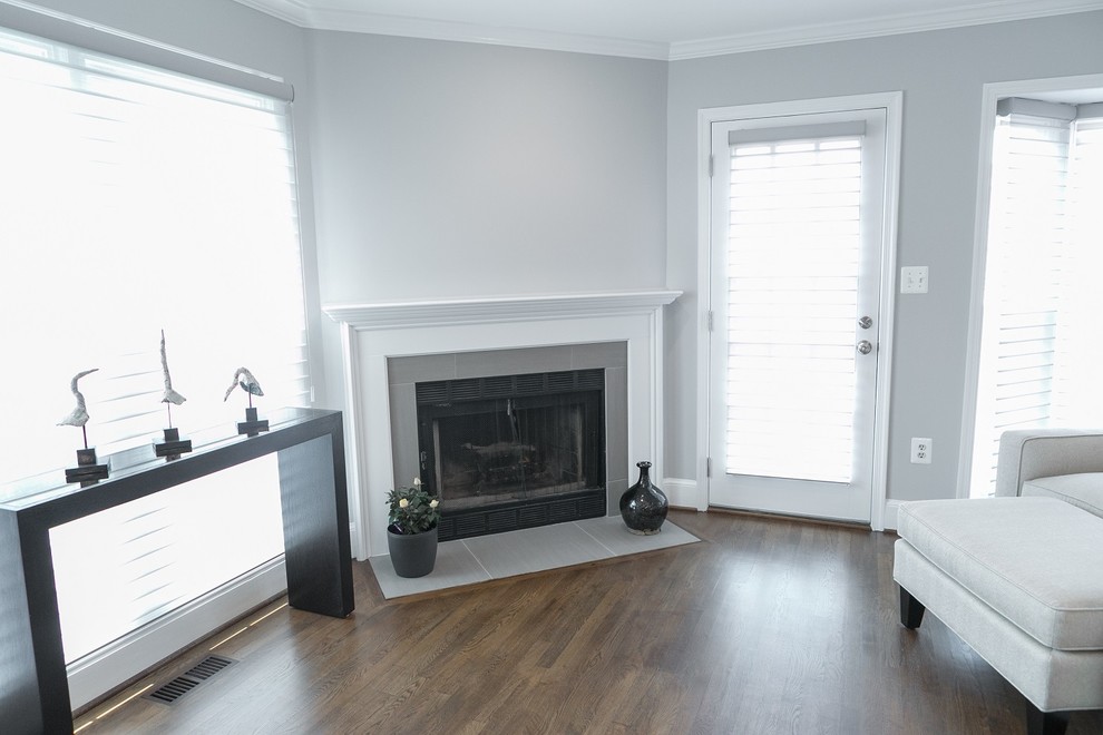 Inspiration for a small classic open plan games room in DC Metro with grey walls, dark hardwood flooring, a standard fireplace, a tiled fireplace surround and no tv.
