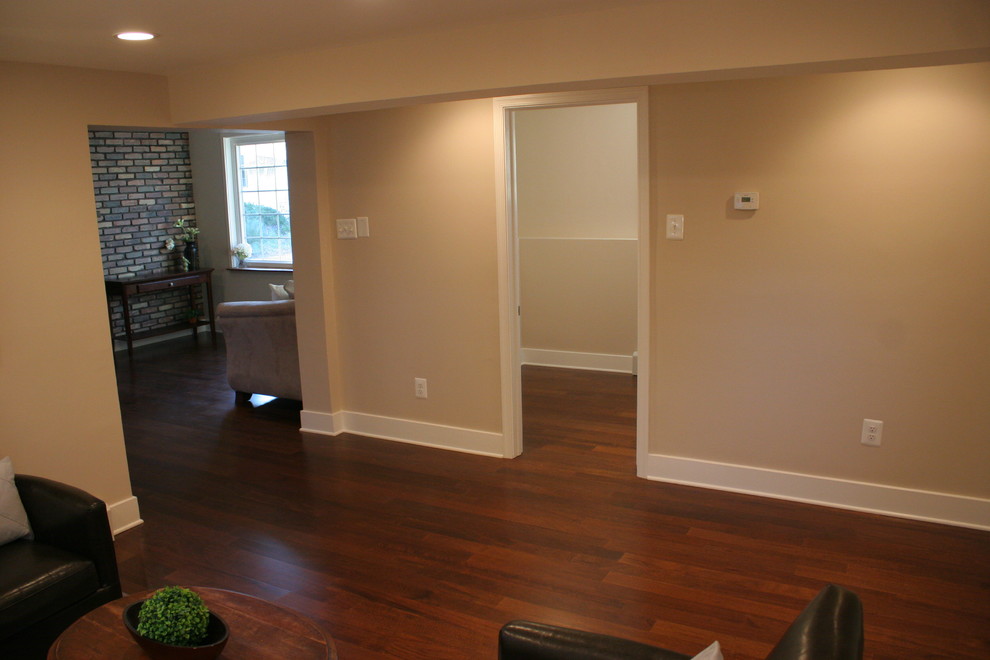 Immagine di un soggiorno minimalista di medie dimensioni e aperto con pareti beige, parquet scuro e nessun camino