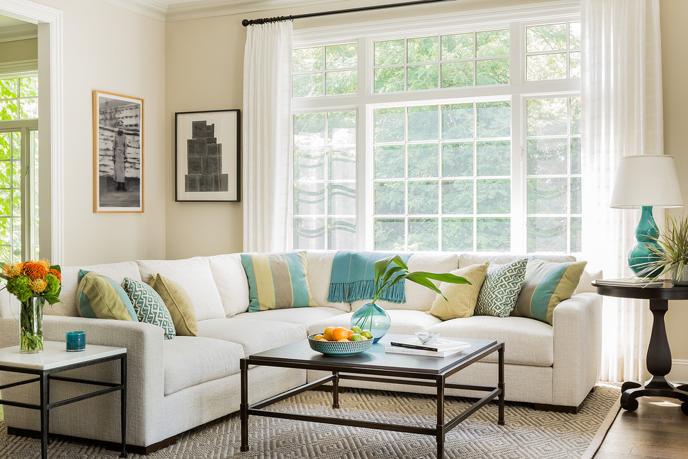 Example of a mid-sized classic open concept medium tone wood floor and brown floor family room design in Boston with beige walls