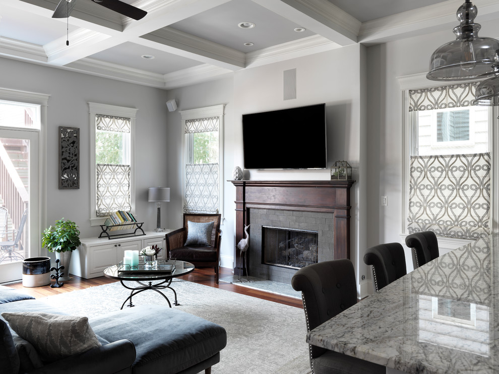 Mid-sized transitional open concept dark wood floor and brown floor family room photo in Boston with gray walls, a standard fireplace, a wall-mounted tv and a tile fireplace