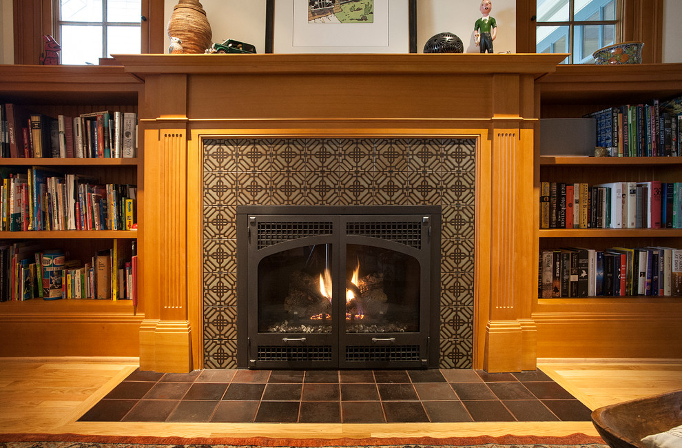 Family room library - mid-sized craftsman medium tone wood floor family room library idea in Portland with white walls, a standard fireplace and a tile fireplace