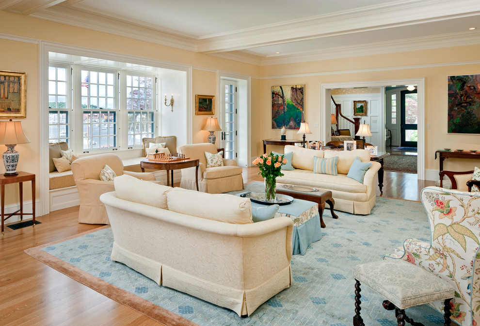 This is an example of a large classic open plan games room in Boston with beige walls, medium hardwood flooring, no fireplace, no tv and beige floors.