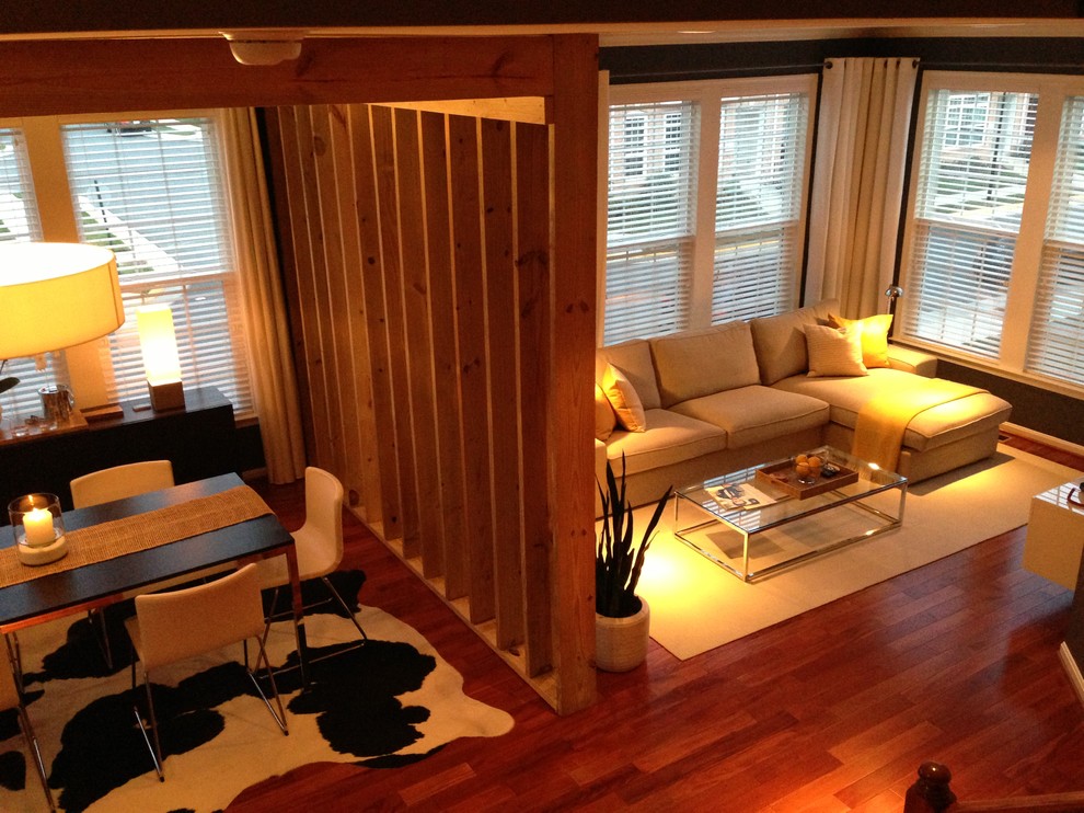Ejemplo de sala de estar abierta moderna grande sin televisor con paredes beige, suelo de madera oscura y todas las chimeneas