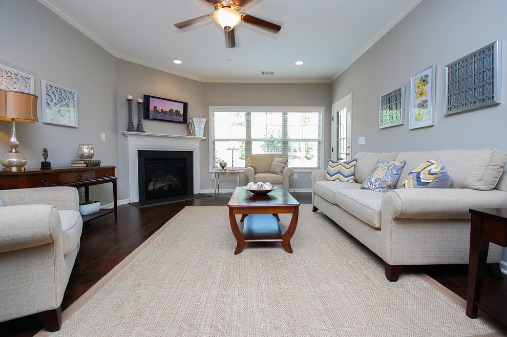 Example of a mid-sized trendy open concept dark wood floor family room design in Other with gray walls, a corner fireplace, a wood fireplace surround and a wall-mounted tv