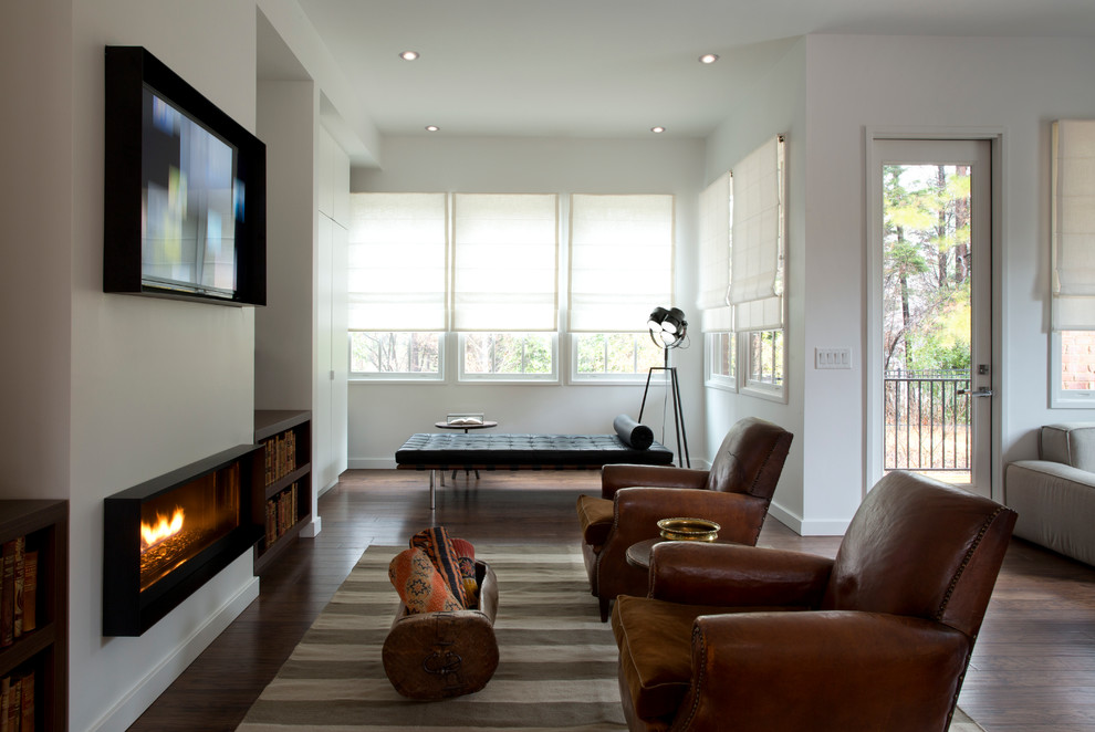 Идея дизайна: гостиная комната в современном стиле с белыми стенами, темным паркетным полом, горизонтальным камином и телевизором на стене