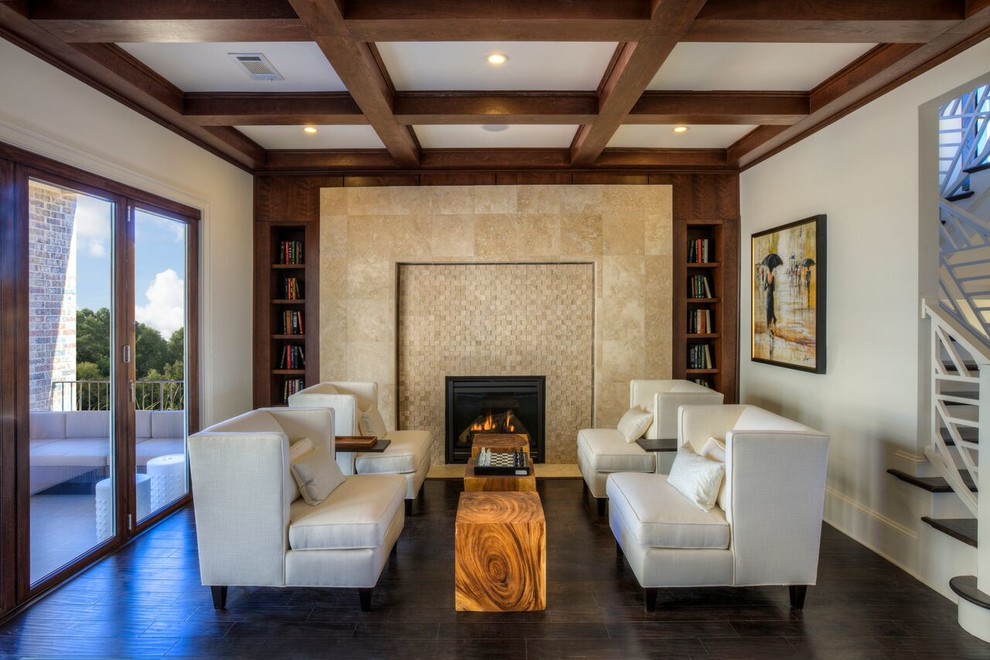 Modelo de sala de estar con biblioteca abierta contemporánea grande con paredes beige, suelo de madera oscura, todas las chimeneas y marco de chimenea de piedra