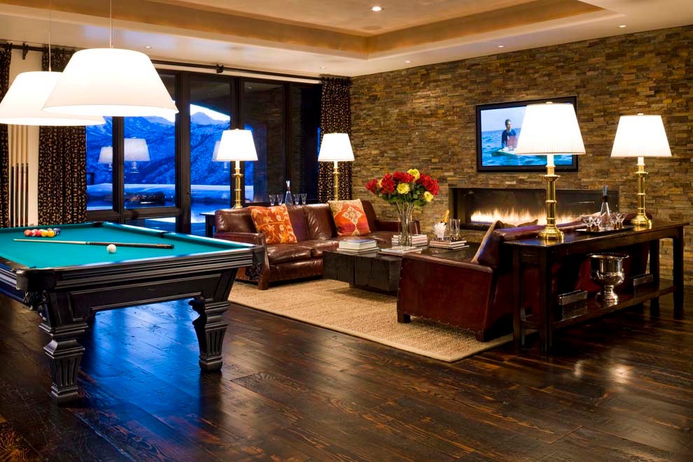 Photo of an expansive classic open plan games room in Denver with a game room, dark hardwood flooring, a ribbon fireplace, a metal fireplace surround and a built-in media unit.