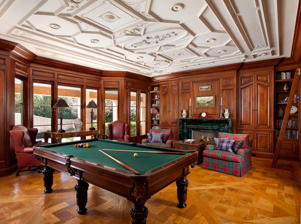 Large traditional enclosed games room in San Francisco with medium hardwood flooring, a standard fireplace, no tv, a stone fireplace surround and brown walls.
