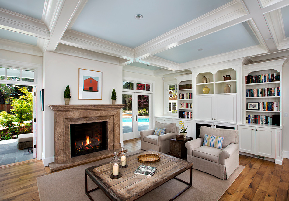 Inspiration for a large timeless open concept medium tone wood floor family room remodel in San Francisco with beige walls, a standard fireplace, a stone fireplace and a media wall