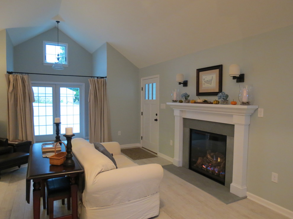 Foto de sala de estar abierta contemporánea de tamaño medio con paredes azules, suelo de baldosas de porcelana y marco de chimenea de piedra