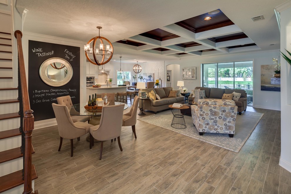 Inspiration for a large transitional open concept laminate floor family room remodel in Jacksonville with gray walls