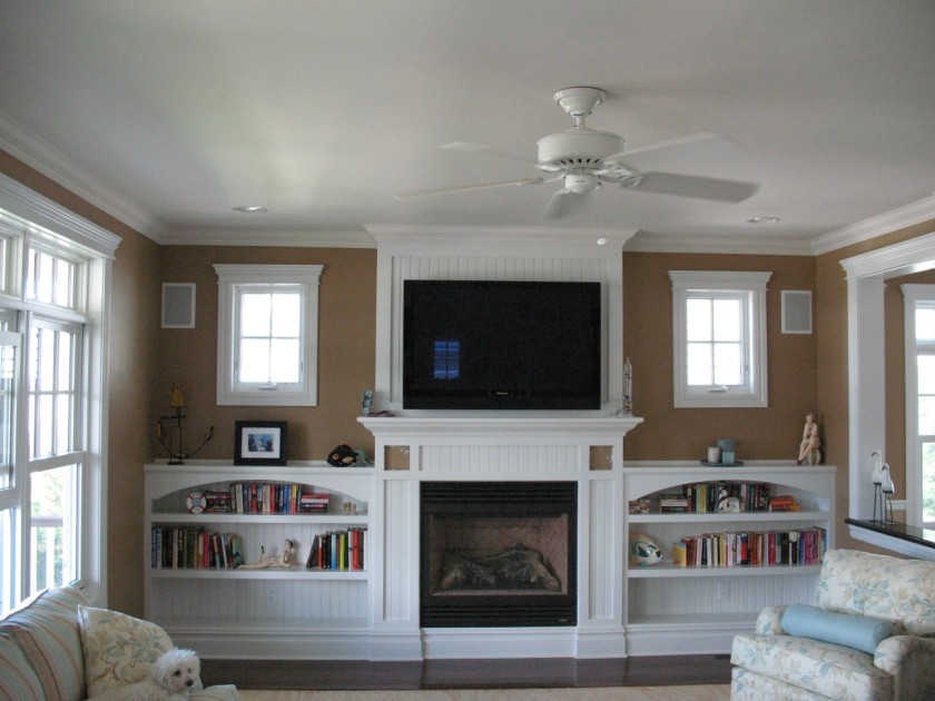 Mid-sized elegant open concept dark wood floor family room photo in New York with beige walls and a wall-mounted tv