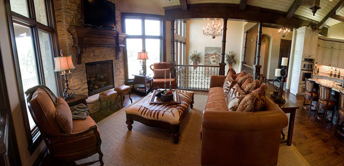 Immagine di un grande soggiorno chic aperto con camino classico e cornice del camino in pietra