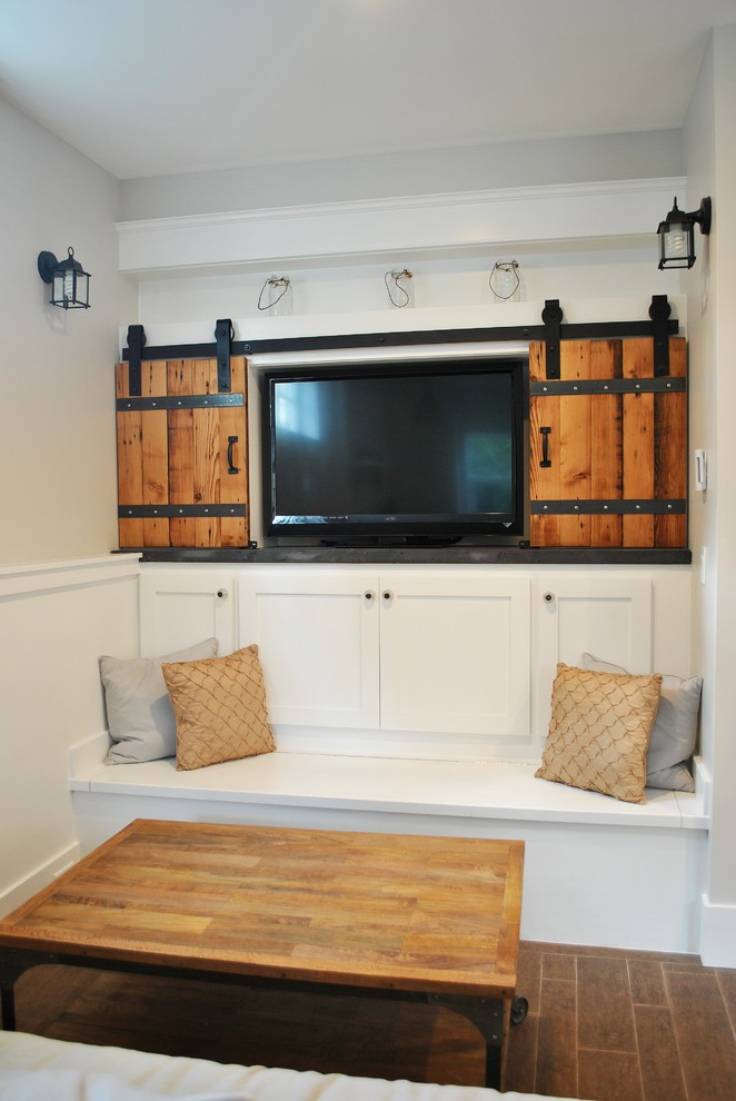 Elegant family room photo in Seattle with a concealed tv