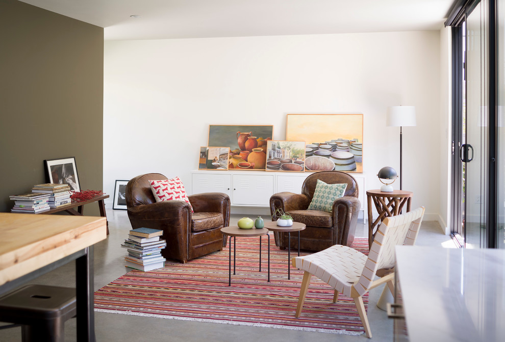 Diseño de sala de estar abierta contemporánea pequeña sin chimenea y televisor con paredes blancas y suelo de cemento
