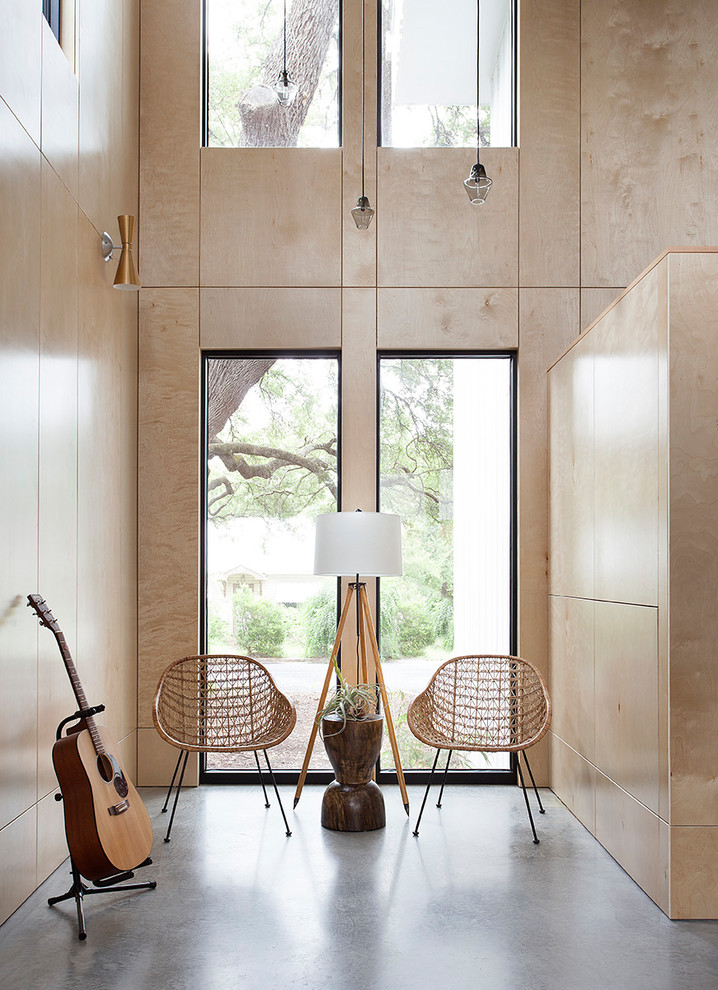 Esempio di un soggiorno minimalista con sala della musica, pavimento in cemento e pavimento grigio