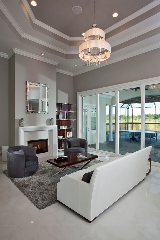 Example of a mid-sized trendy open concept living room design in Other with gray walls, a standard fireplace and a stone fireplace