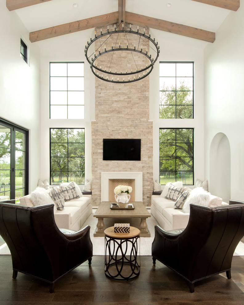 オースティンにある高級な広いコンテンポラリースタイルのおしゃれなLDK (白い壁、濃色無垢フローリング、標準型暖炉、壁掛け型テレビ、石材の暖炉まわり、茶色い床) の写真