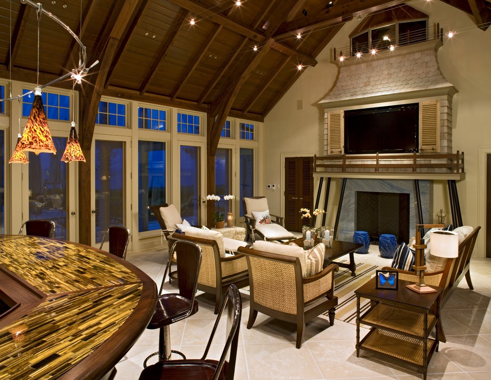 Foto de sala de estar con barra de bar costera grande con paredes beige, suelo de baldosas de cerámica, todas las chimeneas y marco de chimenea de piedra