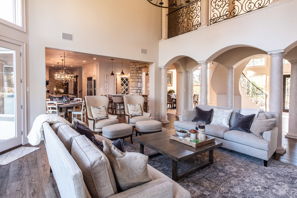 Inspiration for a large open plan games room in Houston with porcelain flooring, a two-sided fireplace, a stone fireplace surround, a wall mounted tv and brown floors.