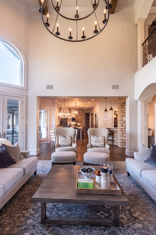 This is an example of a large open plan living room in Houston with porcelain flooring, a two-sided fireplace, a stone fireplace surround, a wall mounted tv and brown floors.