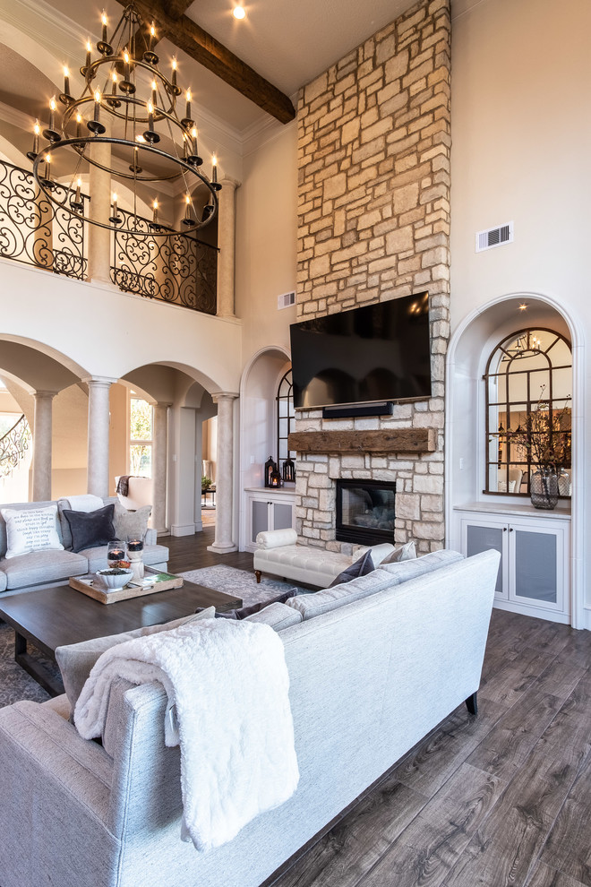 Example of a large open concept porcelain tile and brown floor family room design in Houston with a two-sided fireplace, a stone fireplace and a wall-mounted tv