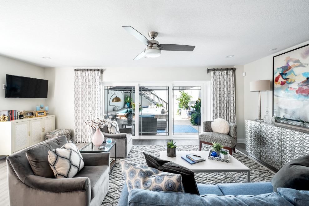 Mittelgroßes, Offenes Stilmix Wohnzimmer mit grauer Wandfarbe, Vinylboden, Eck-TV und braunem Boden in Tampa