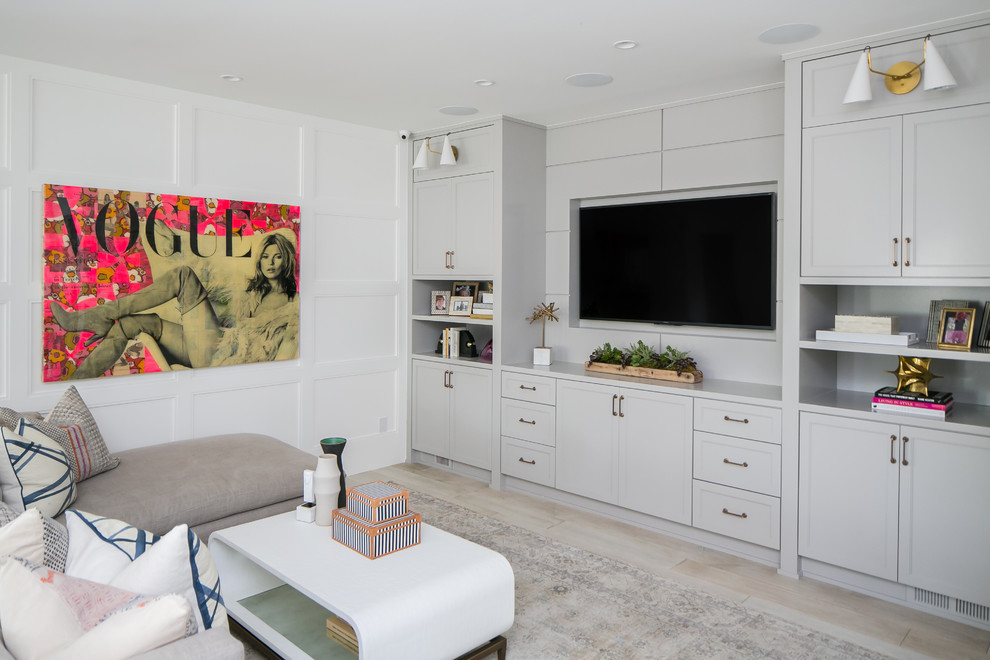 Beach style enclosed light wood floor family room photo in Orange County with multicolored walls and a media wall
