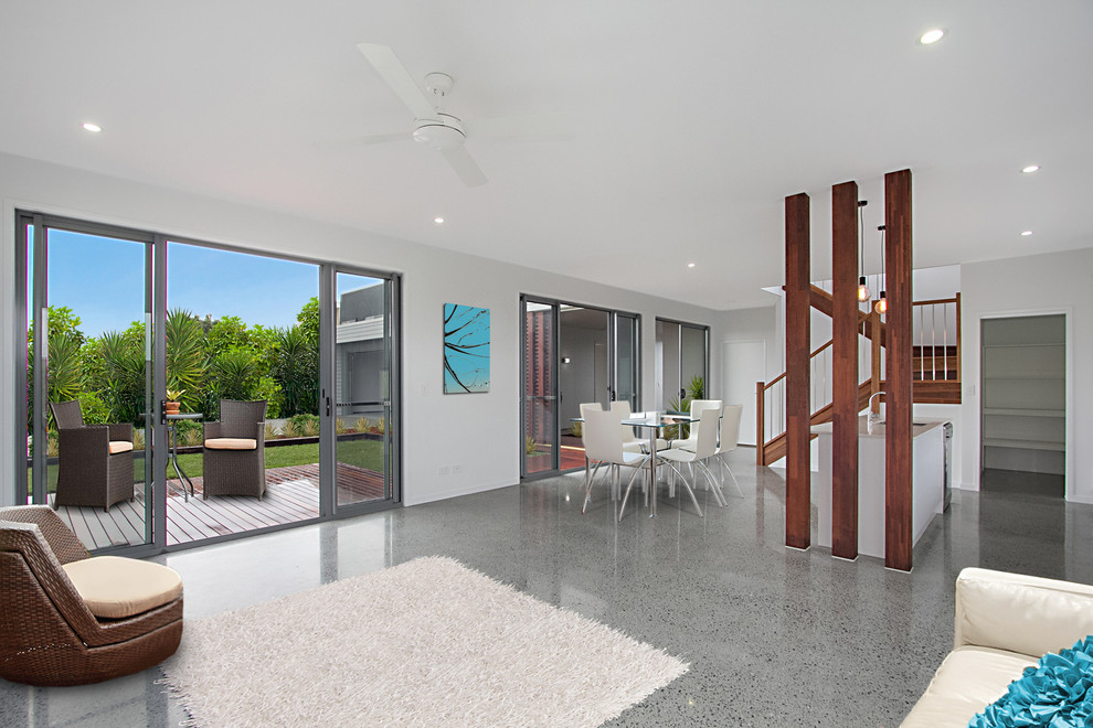 Mid-sized trendy open concept concrete floor family room photo in Gold Coast - Tweed with white walls