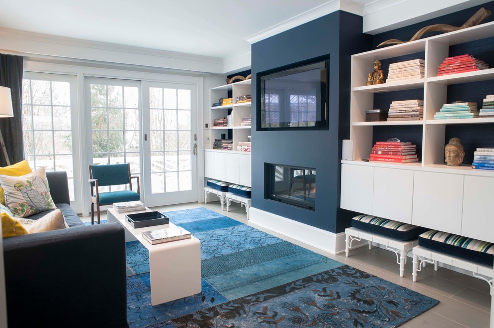 Example of a mid-sized beach style open concept porcelain tile family room library design in Other with white walls, a standard fireplace, a plaster fireplace and a wall-mounted tv