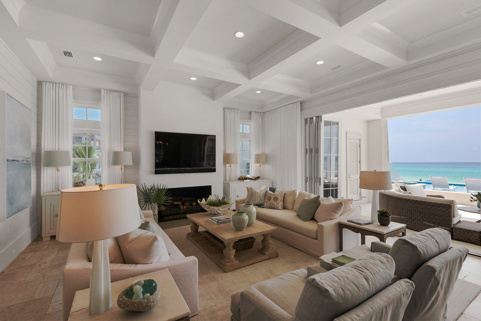 Пример оригинального дизайна: огромная открытая гостиная комната:: освещение в морском стиле с белыми стенами, телевизором на стене, светлым паркетным полом, стандартным камином и фасадом камина из плитки