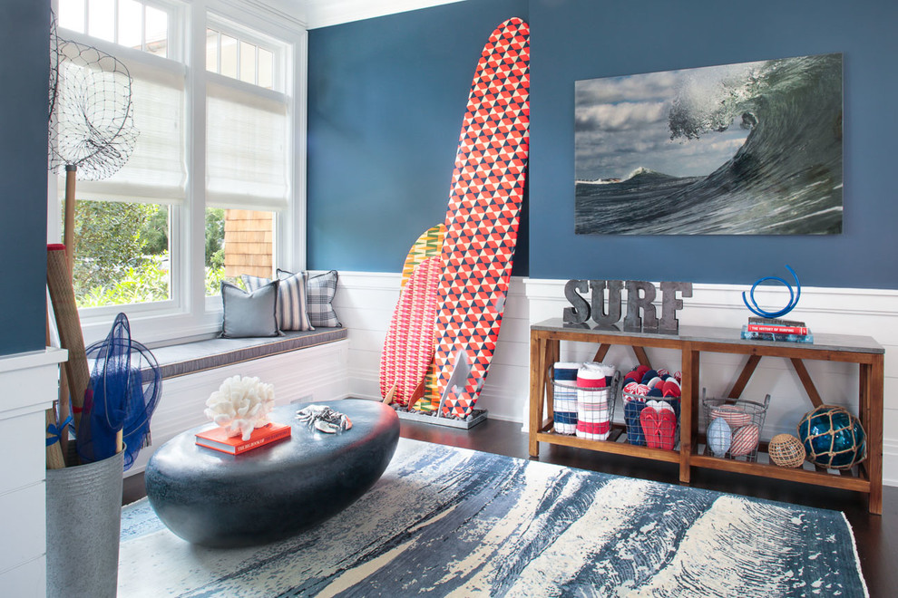Example of a mid-sized beach style enclosed dark wood floor family room design in New York with blue walls and no tv