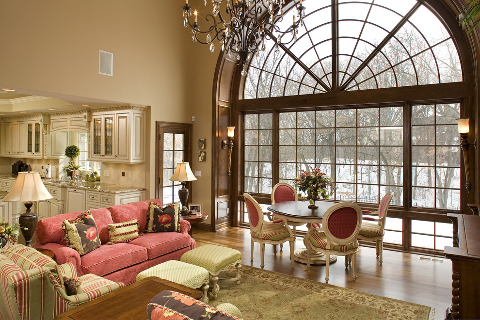 Elegant open concept medium tone wood floor family room photo in Minneapolis with beige walls and no tv