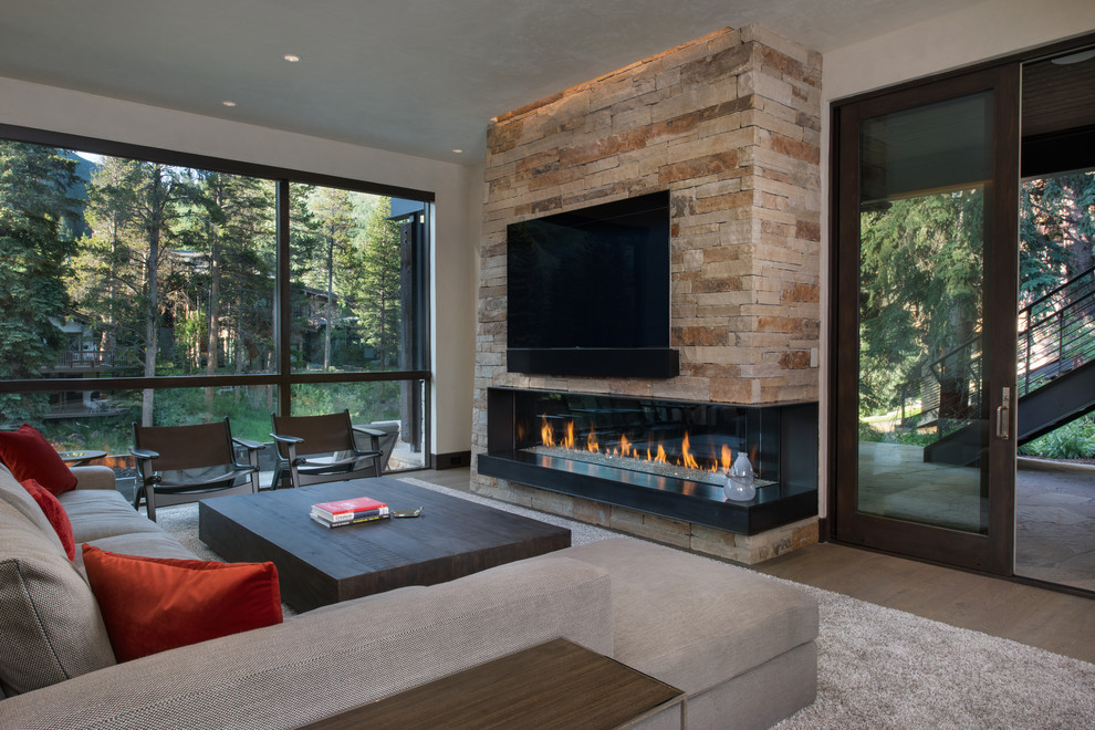 Mid-sized mountain style open concept medium tone wood floor and brown floor family room photo in Denver with a bar, white walls, a corner fireplace, a stone fireplace and a wall-mounted tv