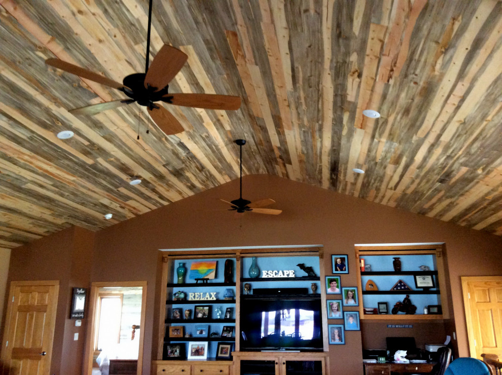 Family room - mid-sized rustic open concept wood ceiling family room idea in Other with brown walls and a media wall