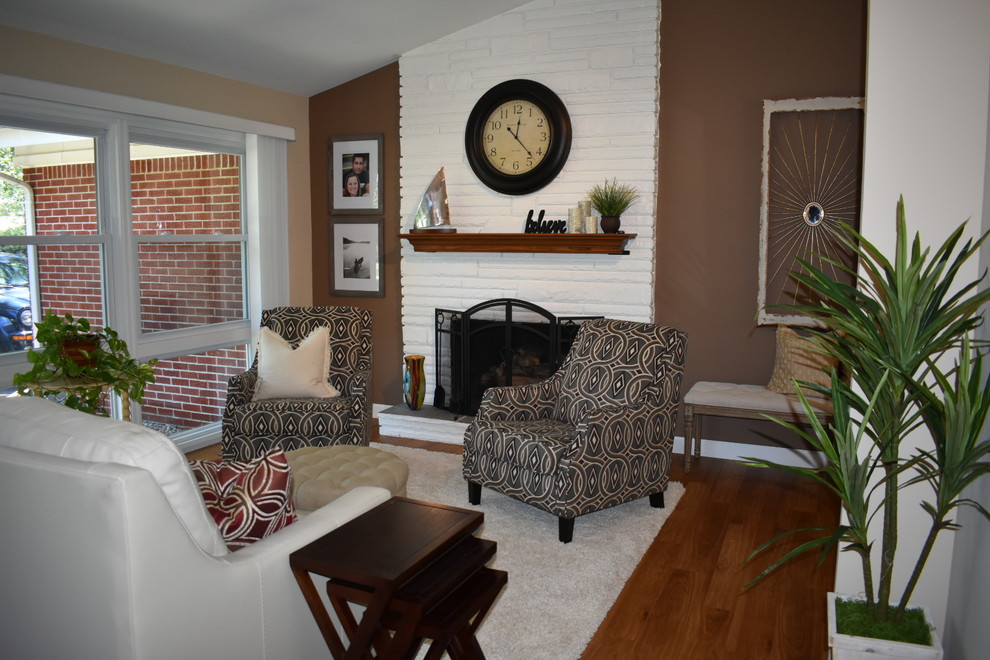 Example of a mid-sized transitional open concept medium tone wood floor and brown floor family room design in Other with brown walls, a standard fireplace and a stone fireplace