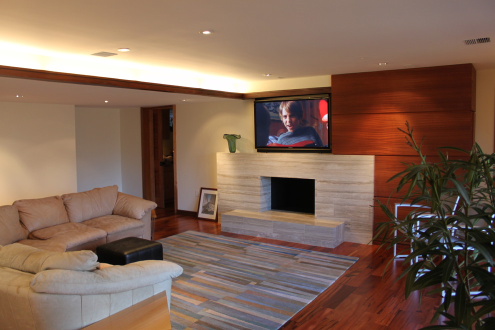This is an example of a large contemporary open plan games room in DC Metro with white walls, medium hardwood flooring, a standard fireplace, a stone fireplace surround and a wall mounted tv.