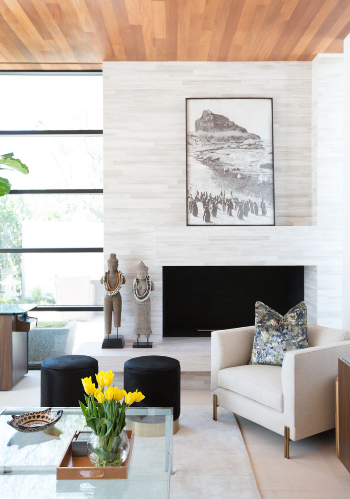 Photo of a medium sized contemporary enclosed living room in Los Angeles with a home bar, white walls, limestone flooring, a corner fireplace, a tiled fireplace surround and a wall mounted tv.