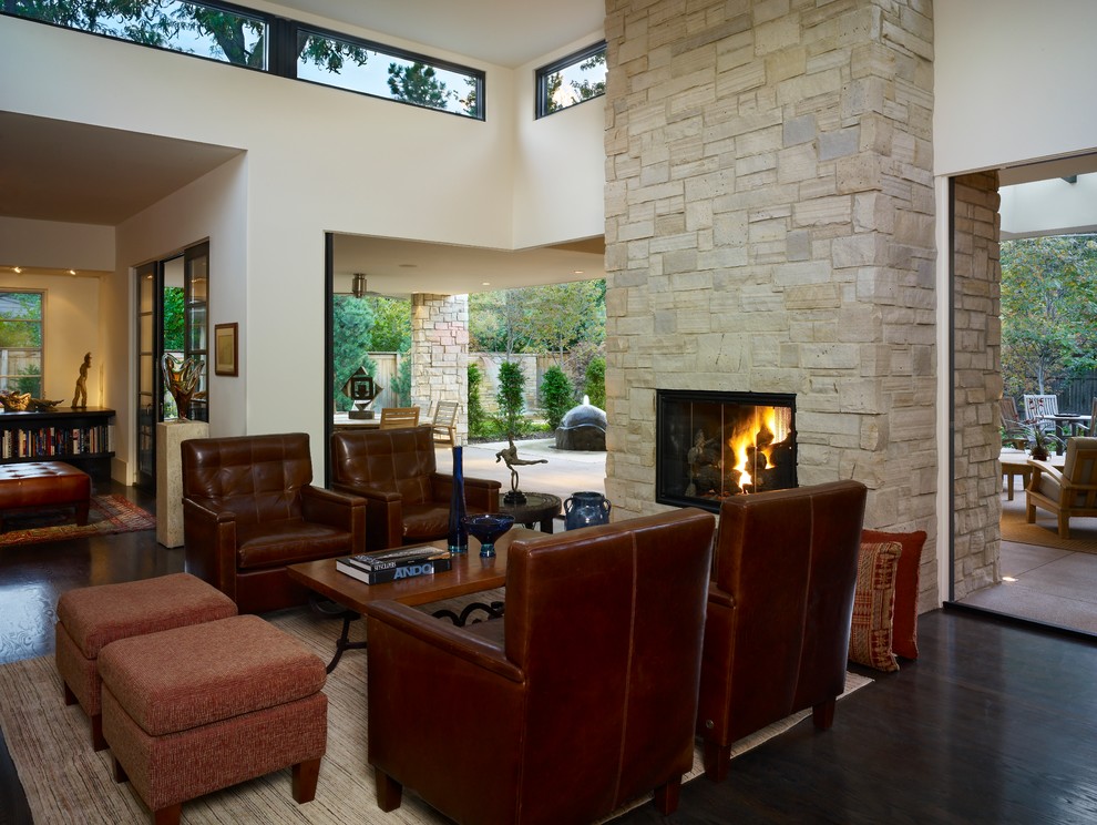Offenes Modernes Wohnzimmer mit beiger Wandfarbe, dunklem Holzboden, Kamin und Kaminumrandung aus Stein in Denver