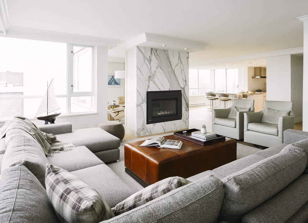 На фото: открытая гостиная комната среднего размера в стиле неоклассика (современная классика) с белыми стенами, светлым паркетным полом, стандартным камином и фасадом камина из камня без телевизора