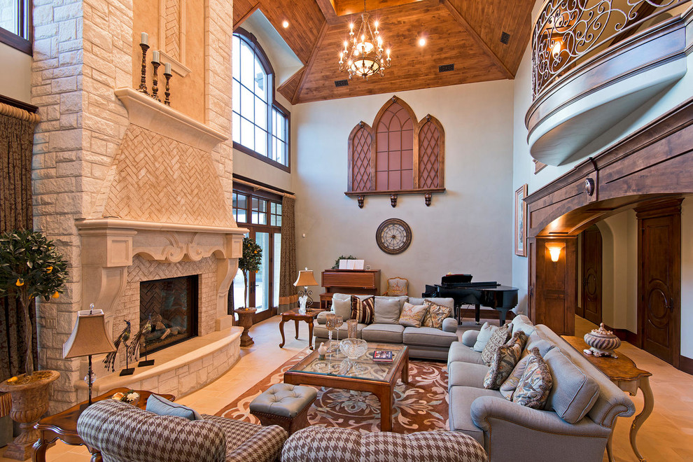 Mediterranean open plan games room in Salt Lake City with beige walls, a standard fireplace, a stone fireplace surround and no tv.